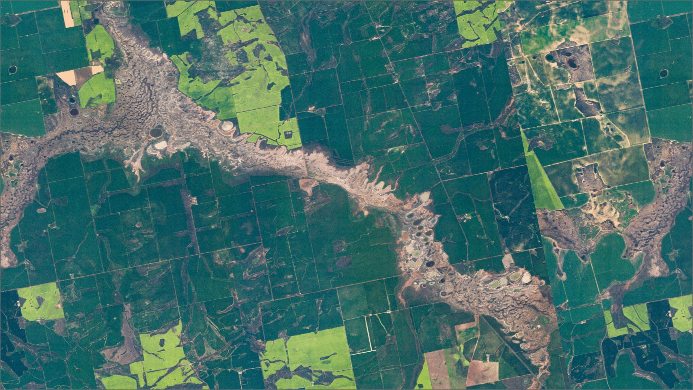 Farmland along a river valley, near-true colour