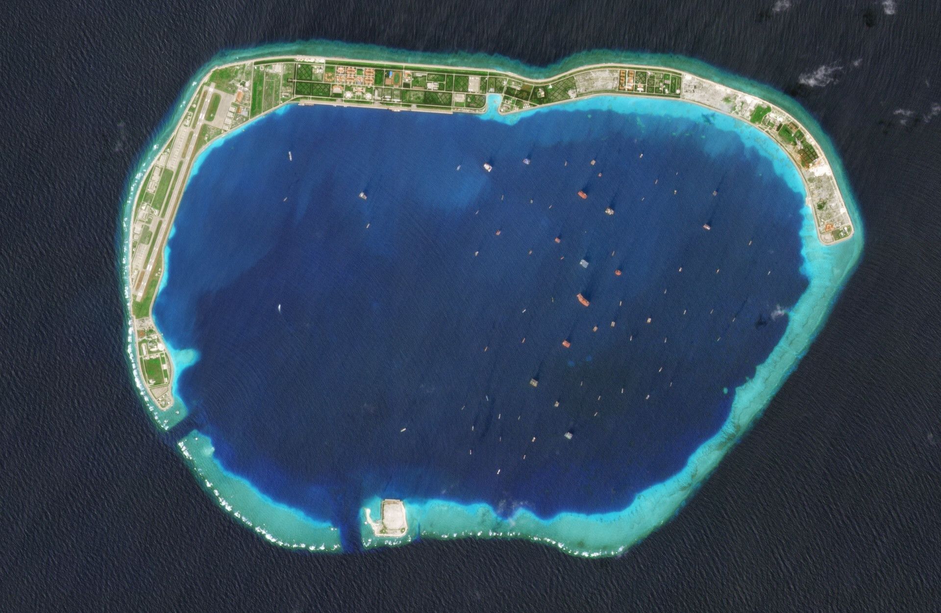 Atoll with vessels at anchor in the lagoon