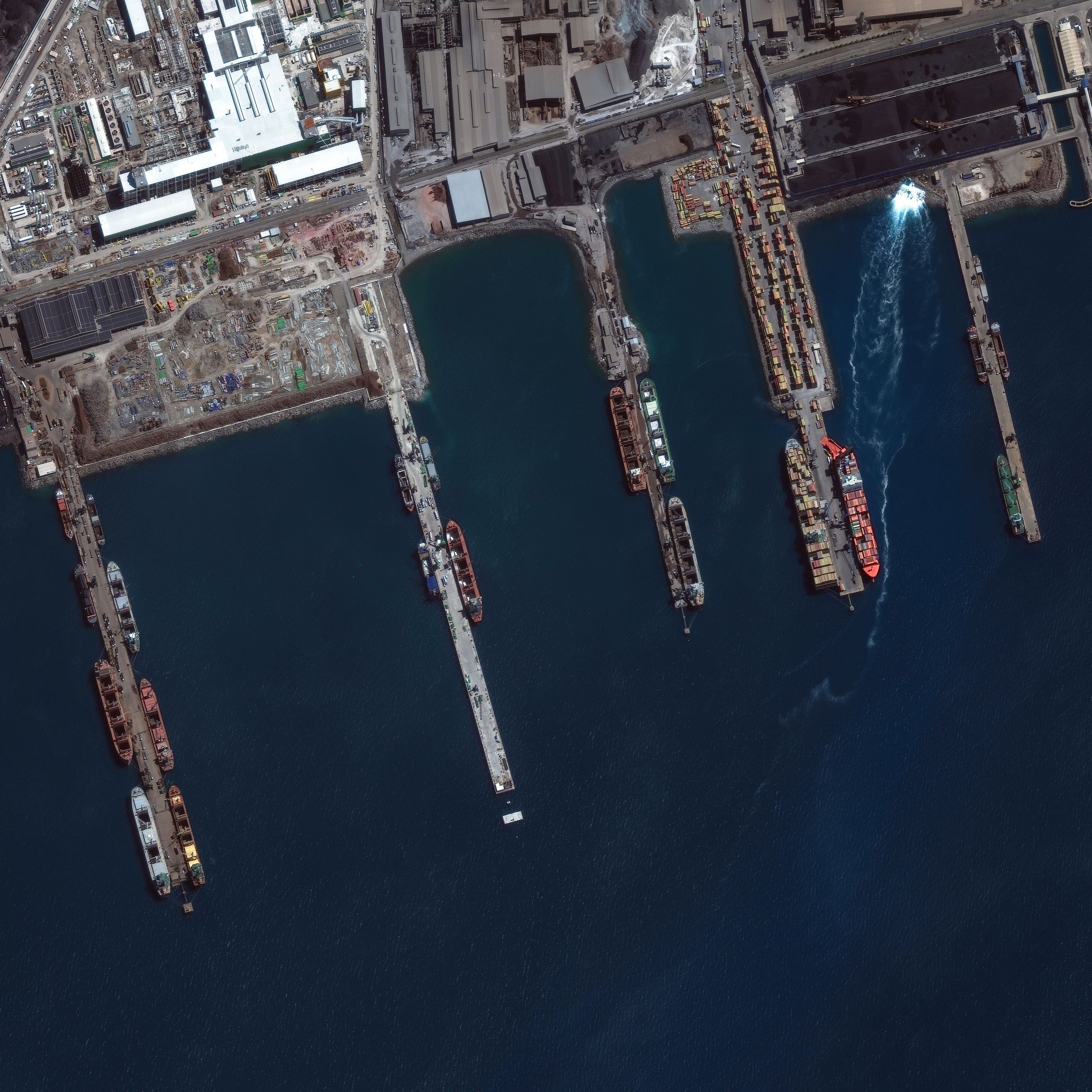 Industrial port with bulk carriers and container ships at 30 cm